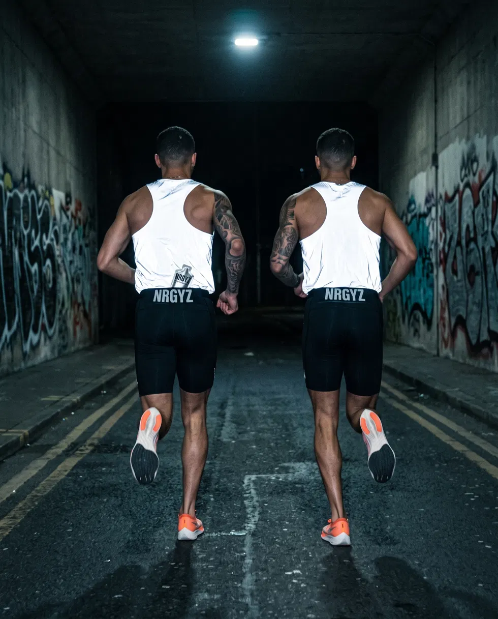 Two runners in a tunnel wearing NRGYZ